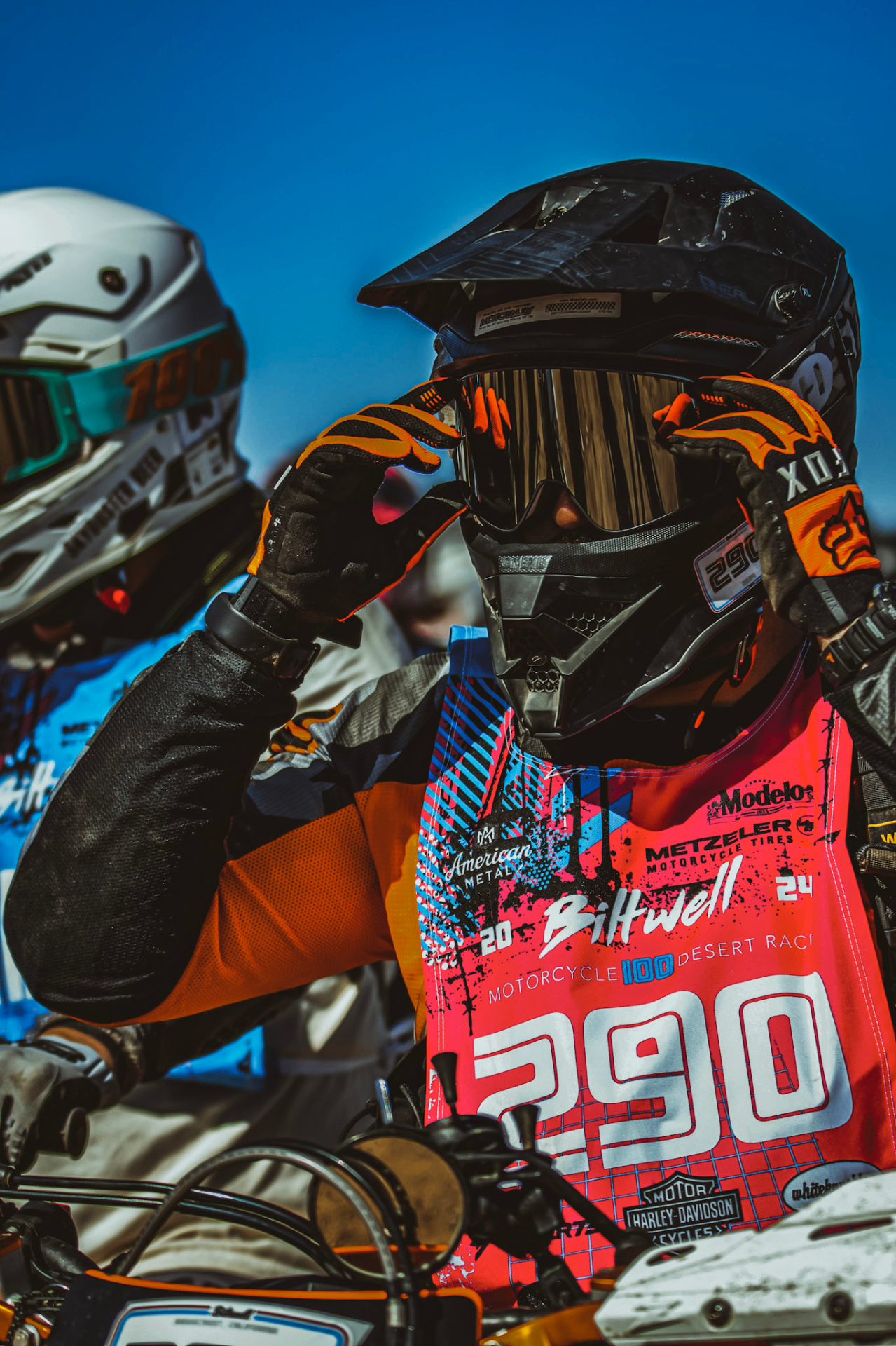 Riding a dirtbike up a mountain trail toward snowy peaks
